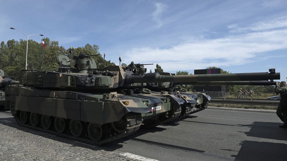 Polish army K2 Black Panther tanks lined up ahead of the Polish Army Day parade in Warsaw, Poland, on Thursday, Aug. 15, 2024. Poland signed a $10 billion agreement to purchase almost a hundred AH-64E Apache attack helicopters from US manufacturer Boeing Co., as Warsaw ramps up its defensive capabilities. Photographer: Damian Lemanski/Bloomberg via Getty Images