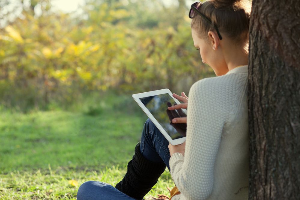 Colorful Close Up of using tablet in the park