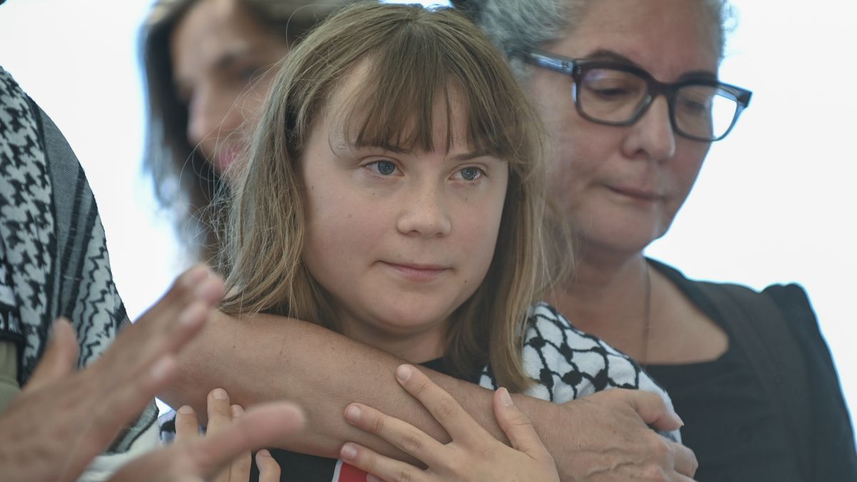 CATANIA, ITALY - JUNE 01: Greta Thunberg, embraced by a woman, joins the ceremony shortly before departing for Gaza, wearing a traditional keffiyeh on June 01, 2025 in Catania, Italy. Swedish activist Greta Thunberg is among those who will attempt to sail to Gaza on a boat organized by the Freedom Flotilla Coalition (FFC), in a bid to break Israel's blockade of the Palestinian territory. Freedom Flotilla had to abort a previous journey in early May after it said its boat came under attack by drones in international waters near Malta. (Photo by Fabrizio Villa/Getty Images)