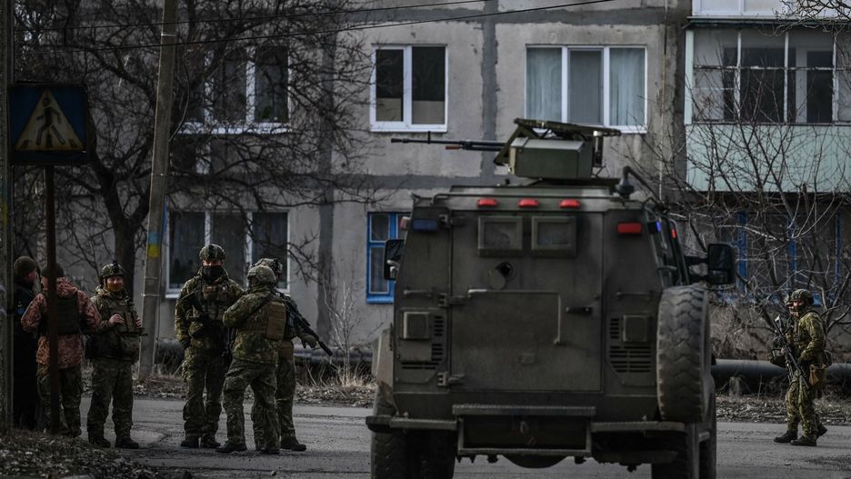 TemporaryUkrainian troops patrol in the town of Novoluhanske, eastern Ukraine, on February 19, 2022. - Ukraine's army said Saturday that two of its soldiers died in attacks in on the frontline with Russian-backed separatists, the first fatalities in the conflict in more than a month. "As a result of a shelling attack, two Ukrainian servicemen received fatal shrapnel wounds," the military command for the separatist conflict said. (Photo by ARIS MESSINIS / AFP)ARIS MESSINIS