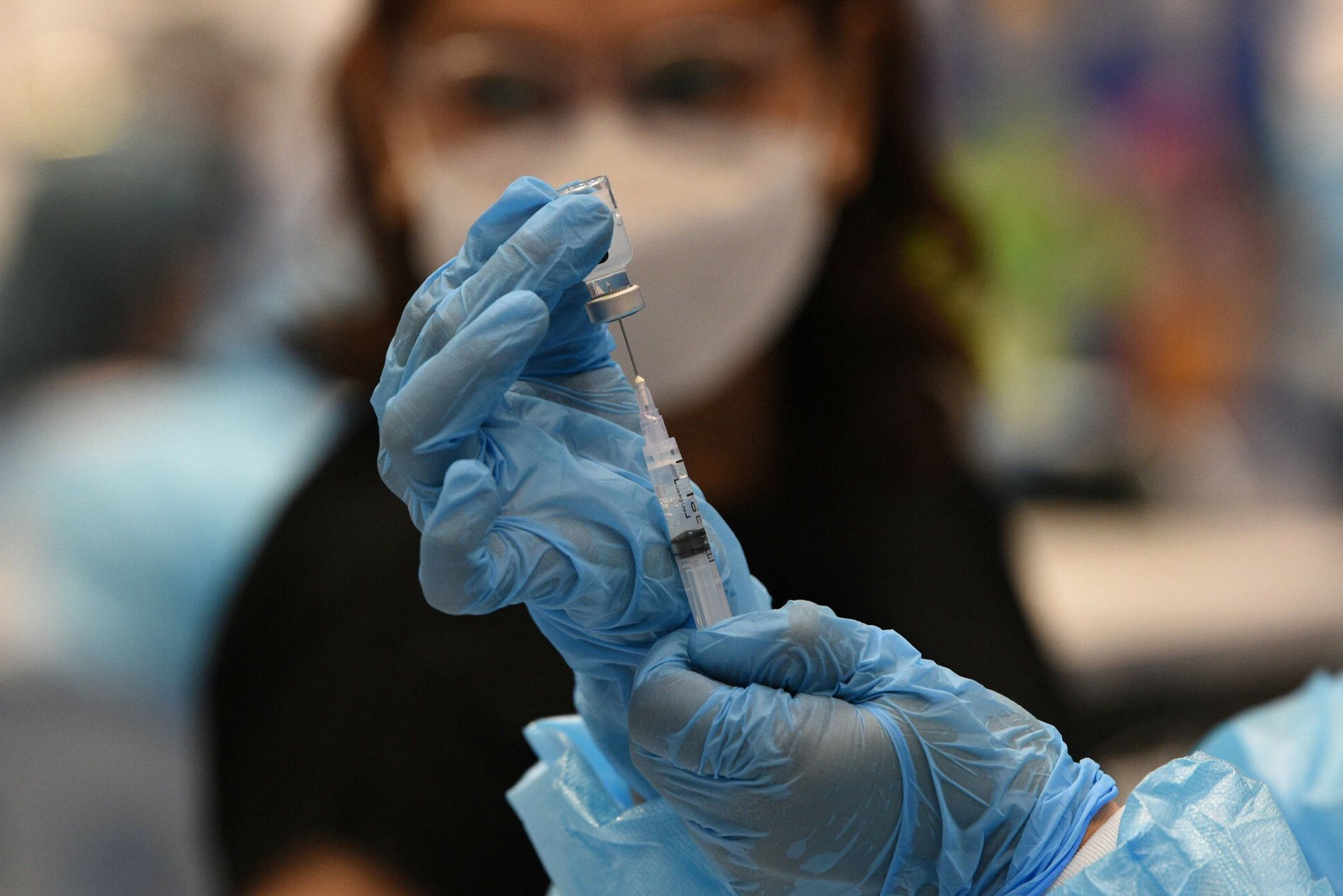 arch48A medical worker prepares a BioNtech-Pfizer Covid-19 coronavirus vaccine at a colisium in Makati City, suburban Manila on November 29, 2021, as the Southeast Asian nation launched a three-day vaccination drive targeting nine million people as young as 12 in an effort to accelerate the roll-out of jabs, amidst the threat of heavily mutated coronavirus variant Omicron. (Photo by Ted ALJIBE / AFP)TED ALJIBE