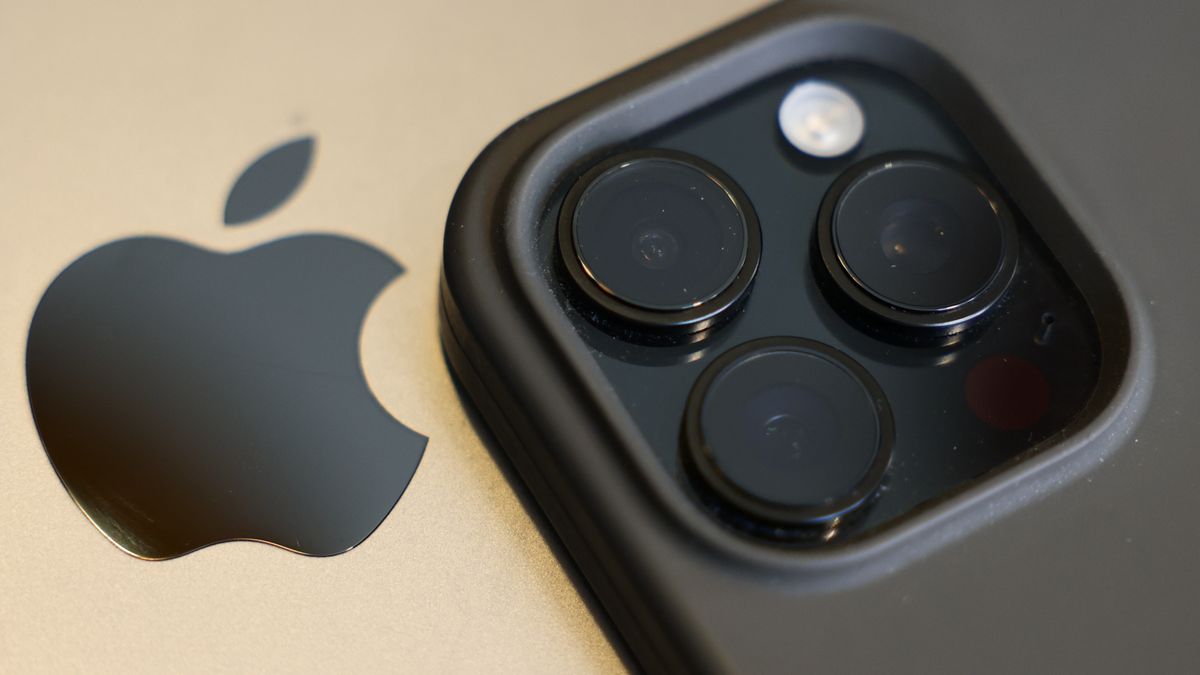 Apple logo on MacBook and iPhone 16 Pro are seen in this illustration photo taken in Krakow, Poland on April 7, 2025. (Photo by Jakub Porzycki/NurPhoto via Getty Images)