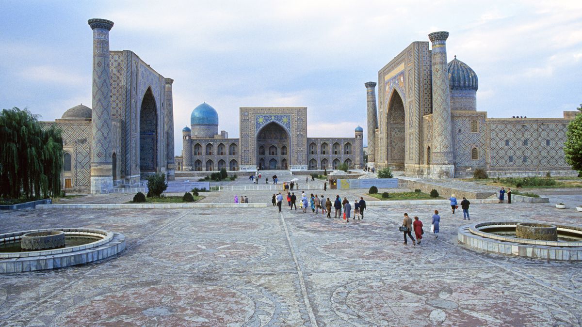 Pilgrims and tourists wander the grounds of the three huge mosque and madrasa, the Ulugh Beg Madrasah (14171420), the Sher-Dor Madrasah (16191636), and the Tilya-Kori Madrasah (16461660), at Registan Square, in the city of Samarkand, Uzbekistan on the Great Silk Road, 2003. (Photo By Buddy Mays/Getty Images).