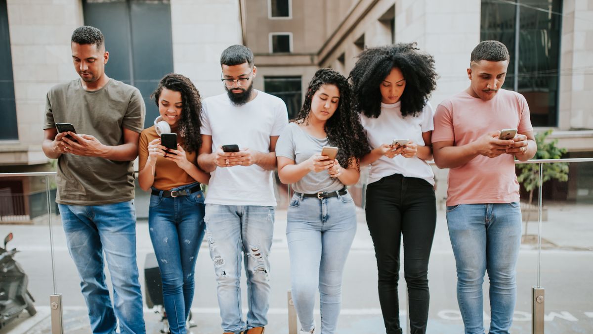 group of young people using smartphone
