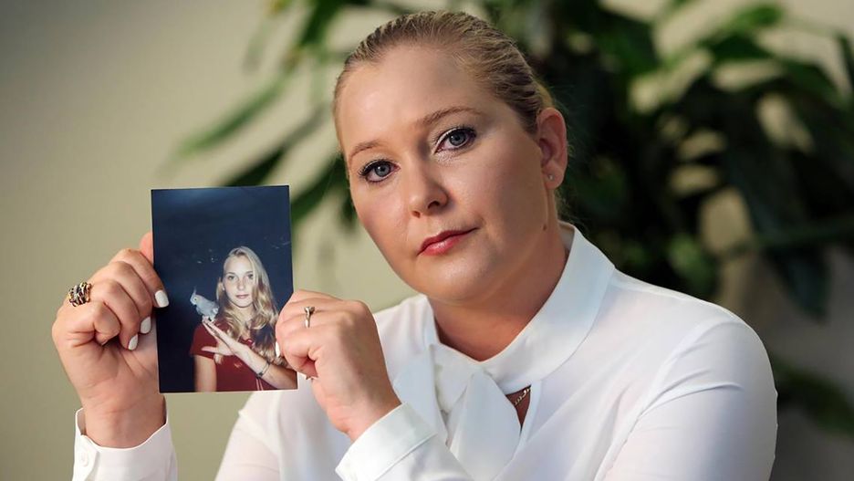 Virginia Roberts Giuffre, with a photo of herself as a teen, when she says she was abused by Jeffrey Epstein, Ghislaine Maxwell and Prince Andrew, among others. (Emily Michot/Miami Herald/Tribune News Service via Getty Images)