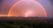 Co za piorunujące ujęcie. Fotograf uchwycił błyskawicę pod podwójną tęczą