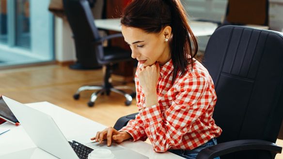 Young woman working on laptop in the office