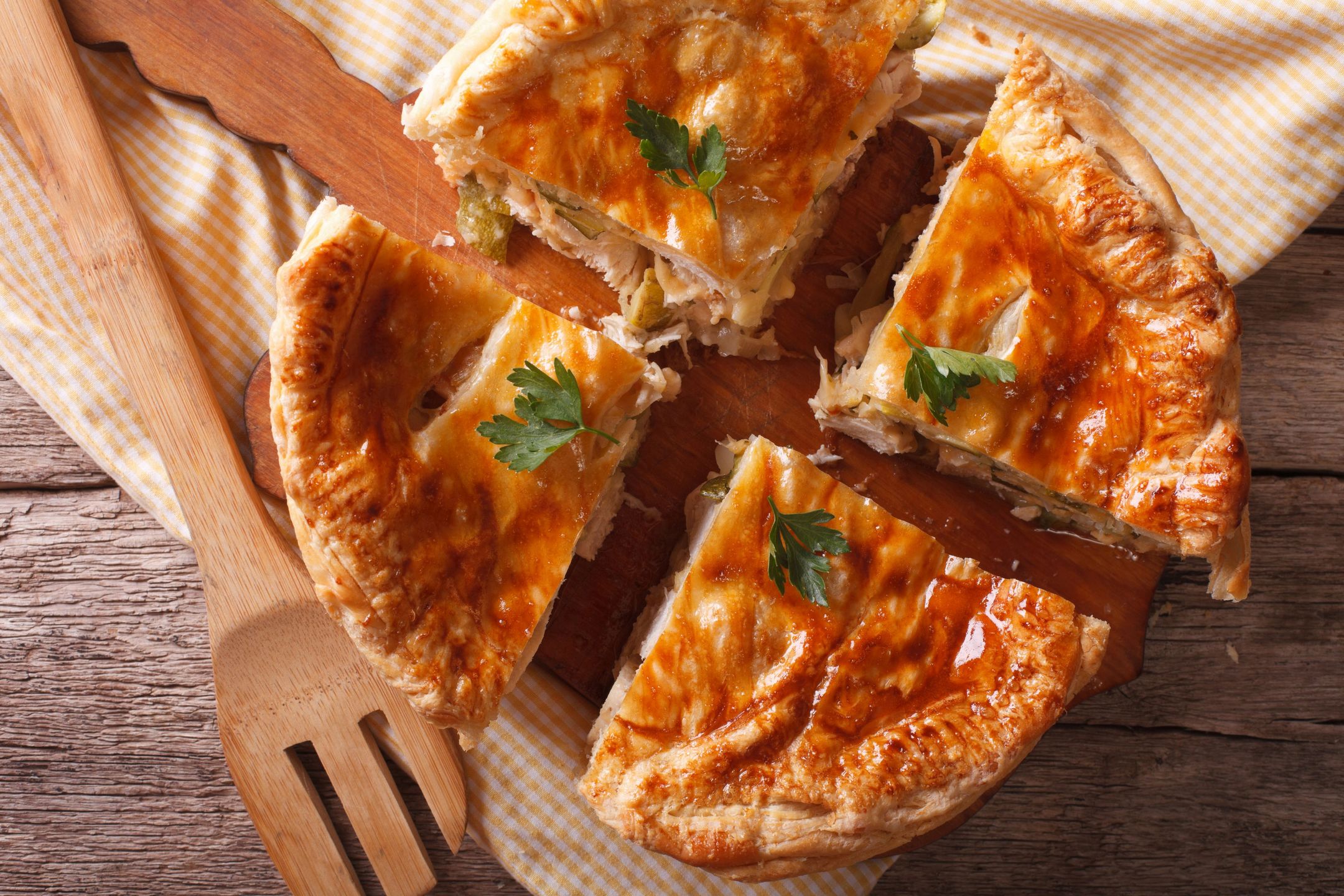 Homemade chicken pie sliced close-up on the table. horizontal view from above