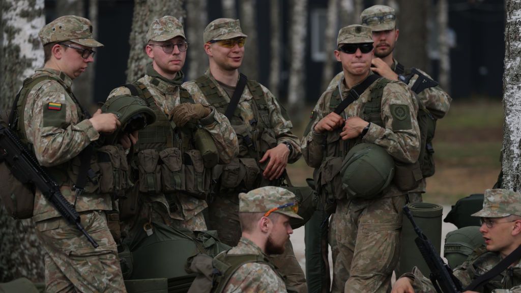 Lithuania To Host German Military Brigade Long Term
RUDNINKAI, LITHUANIA - MAY 28: Reservists in an infantry unit of the Lithuanian Army relax during training at a military site that is to become home for 5,000 German troops on May 28, 2024 near Rudninkai, Lithuania. The site, located approximately 12km from the border to Belarus, is a former Soviet military training ground. Germany, which already has a strong military presence in Lithuania as part of an international NATO force, will deploy 5,000 troops with heavy equipment in its "Lithuania Brigade" on a long-term commitment to help deter aggression from Russia. The brigade is scheduled to be fully operational by 2027. (Photo by Sean Gallup/Getty Images)
Sean Gallup