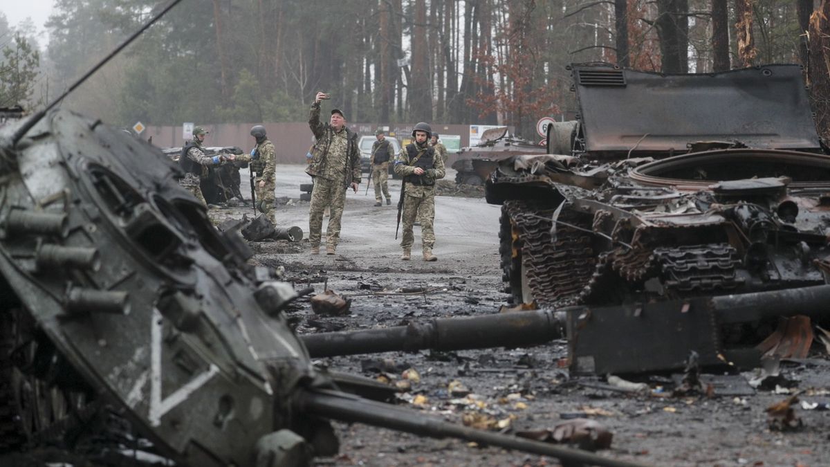 Ukraińscy żołnierze obok zniszczonych rosyjskich czołgów 