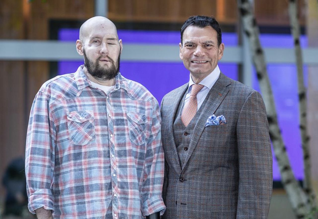 Patient Aaron James with his attending physician, Doctor Eduardo D. Rodriguez, a few months after a successful face transplant surgery.