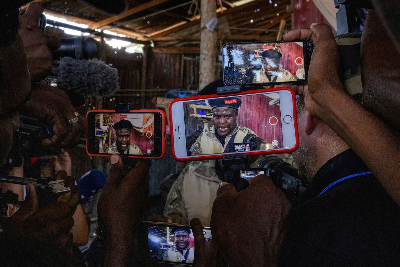 3.11.2021 r., Haiti. Dziennikarze nagrywają oficera policji Jimmy'ego "Barbecue" Cheriziera, przewodniczącego koalicji G9, który oprowadzał ich po La Saline w Porte-au-Prince.