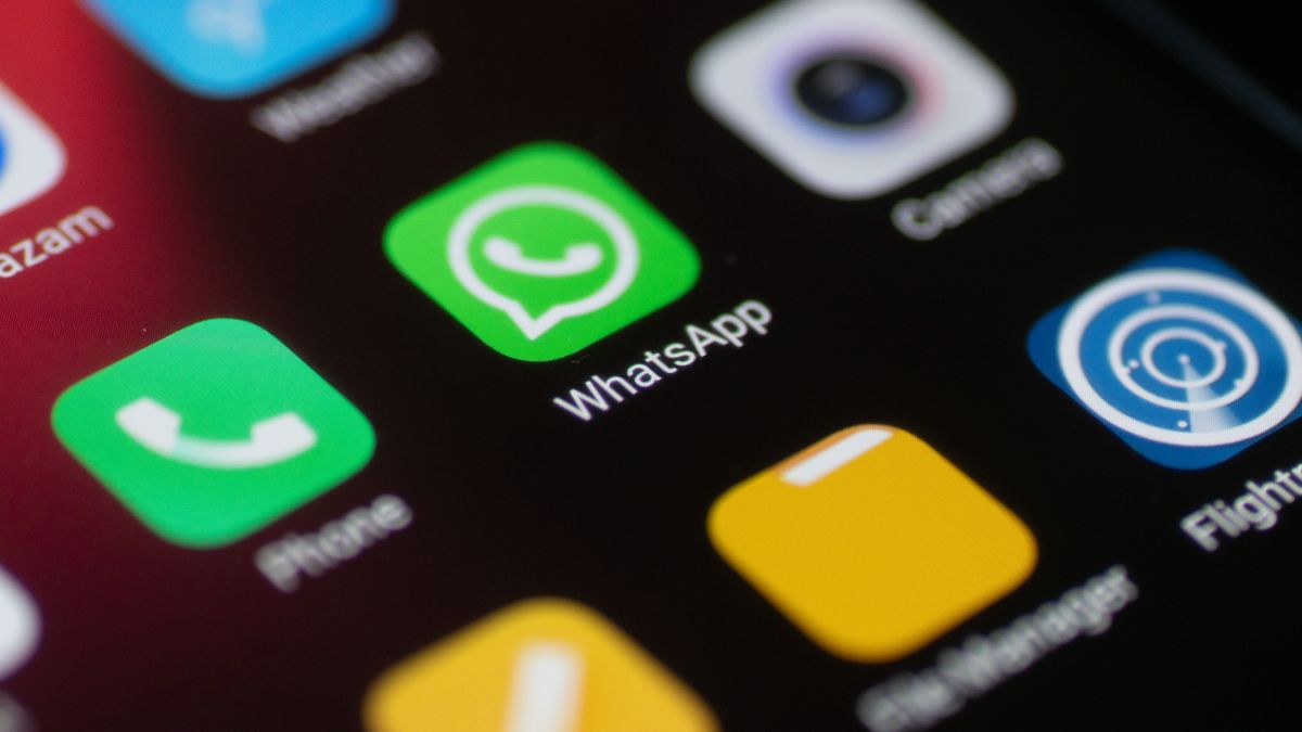 WhatsApp logo displayed on a phone screen, smartphone and keyboard are seen in this multiple exposure illustration. WhatsApp Messenger is a multiplatform mobile application that provides an encrypted instant messaging system belonging to Facebook, photo taken in Amsterdam, Netherlands on January 28, 2020 (Photo illustration by Nicolas Economou/NurPhoto via Getty Images)