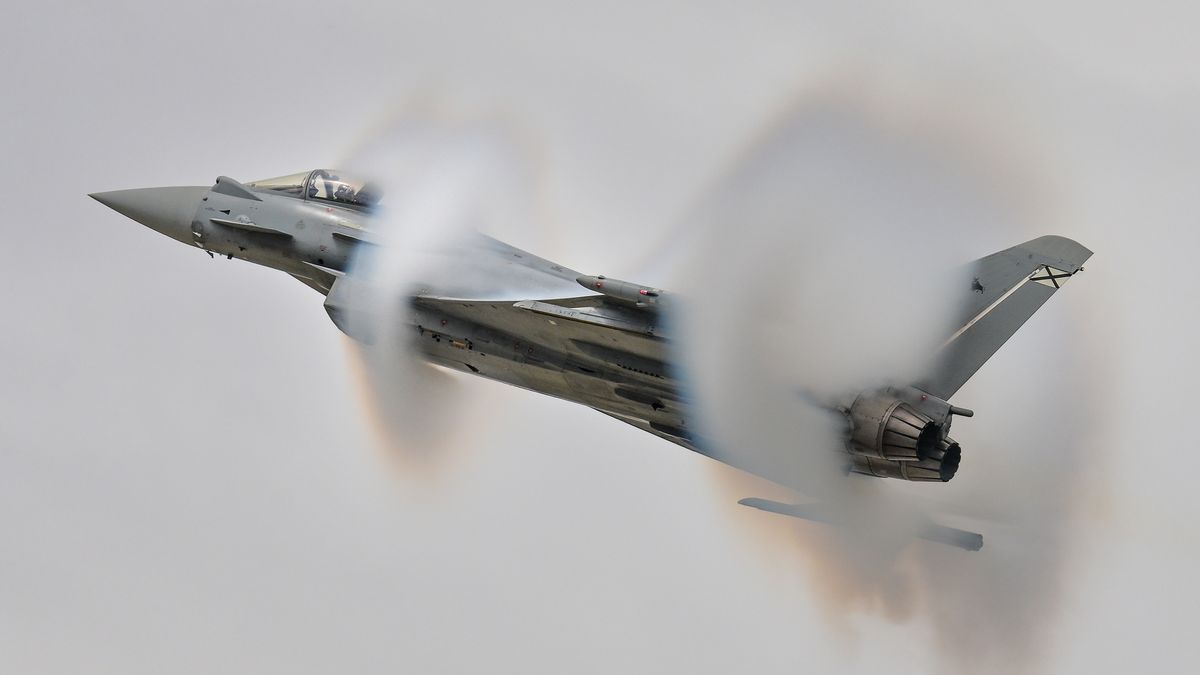 The Spanish Air & Space Force Eurofighter C.16 Typhoon from Ala 14 creates moisture clouds as it performs during the Royal International Air Tattoo at RAF Fairford in Gloucestershire, England, on July 19, 2025. (Photo by Jon Hobley | MI News/NurPhoto via Getty Images)