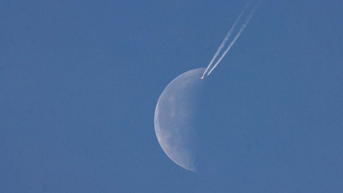 A passenger plane is cruising at 40.000 feet altitude and passing in front of the half moon, on a cloudless sunny spring day as the aircraft is flying over Europe in the Dutch sky. Moonpass is the ultimate goal of aviation photographers, the planespotters. During the flight, the passenger jet is leaving behind contrails or condensation trail, a white vapor line as it passes in front of Earth's natural satellite and closest celestial object in the universe. Eindhoven, The Netherlands on April 24, 2022. (Photo by Nicolas Economou/NurPhoto via Getty Images)