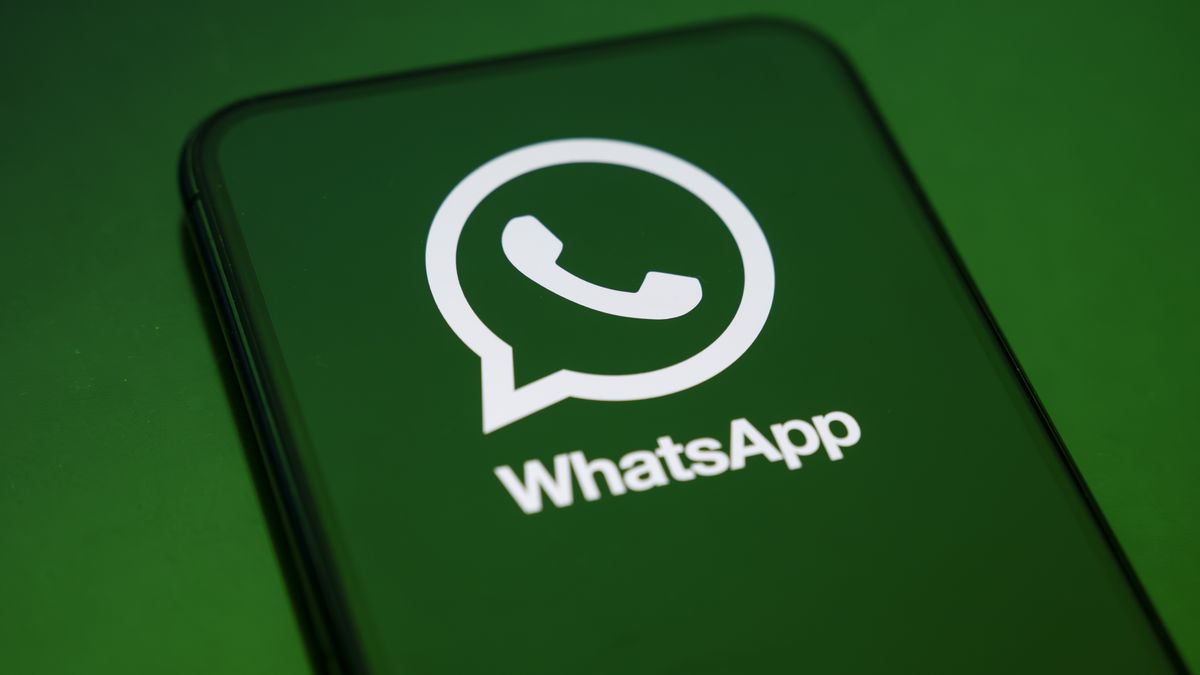 In Créteil, France, on September 29, 2025, the WhatsApp logo appears on a smartphone reflecting a green illustration. Meta, the parent company of WhatsApp and Meta AI, makes the Artificial Intelligence assistant mandatory in its instant messaging app. (Photo Illustration by Samuel Boivin/NurPhoto via Getty Images)