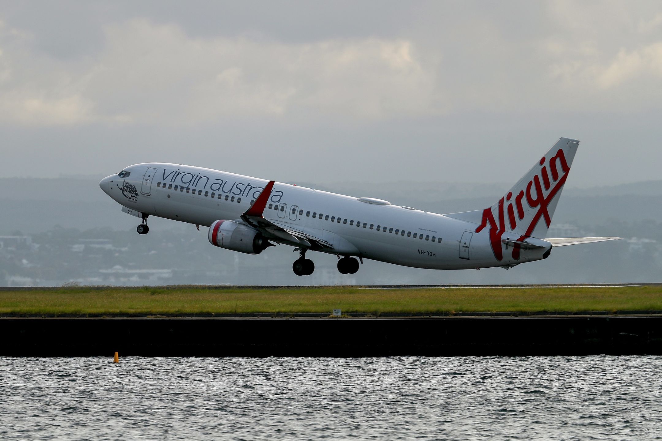 A Boeing Co. 737 aircraft operated by Virgin Australia Holdings Pty Ltd. takes off at Sydney Airport in Sydney, Australia, on Wednesday, Feb. 8, 2023. Virgin Australia is considering taking on new debt in order to hand cash to owner Bain Capital just months ahead of the airline's prospective initial public offering, according to people familiar with the matter. Photographer: Brendon Thorne/Bloomberg via Getty Images