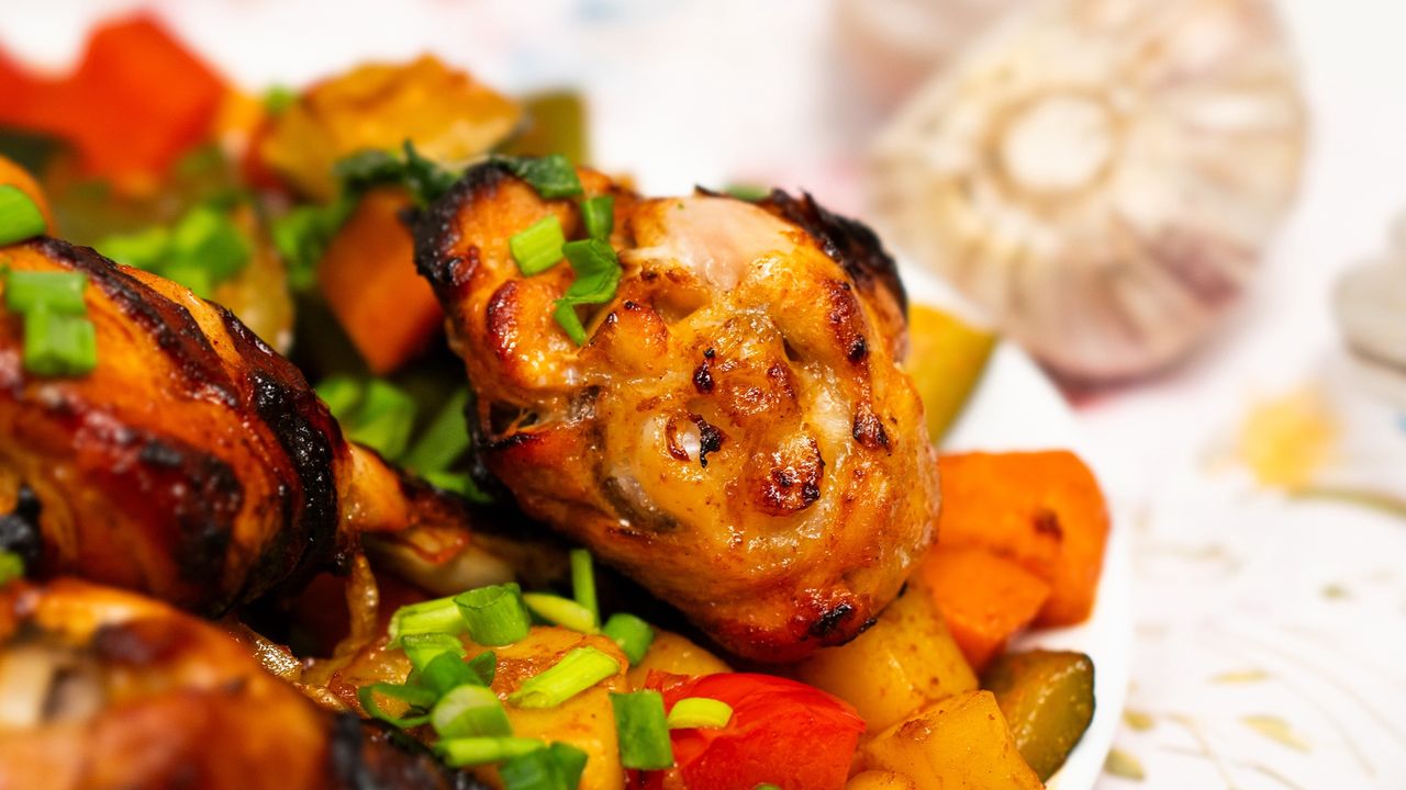 Hanging pieces of chicken with vegetables