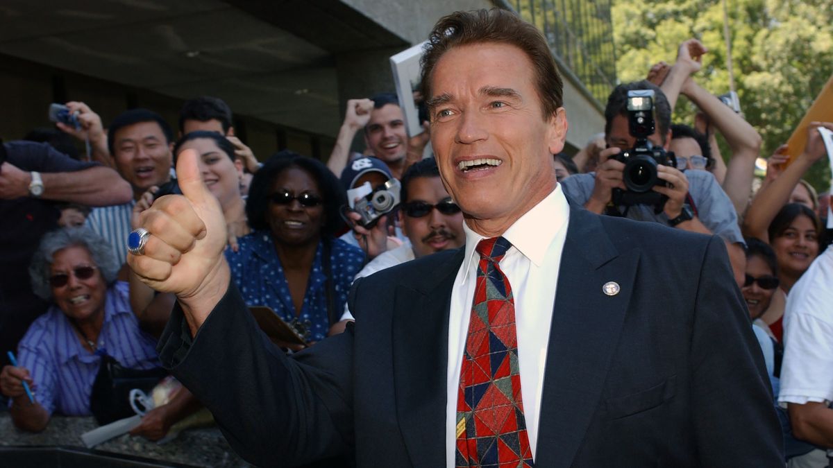 Fans greeted Actor Arnold Schwarzenegger as he arrived at Los Angeles County Registrar's Office after filing his paperwork for Governor of California, August 7, 2003 in Norwalk, California. (Photo by Bob Riha, Jr./Getty Images)