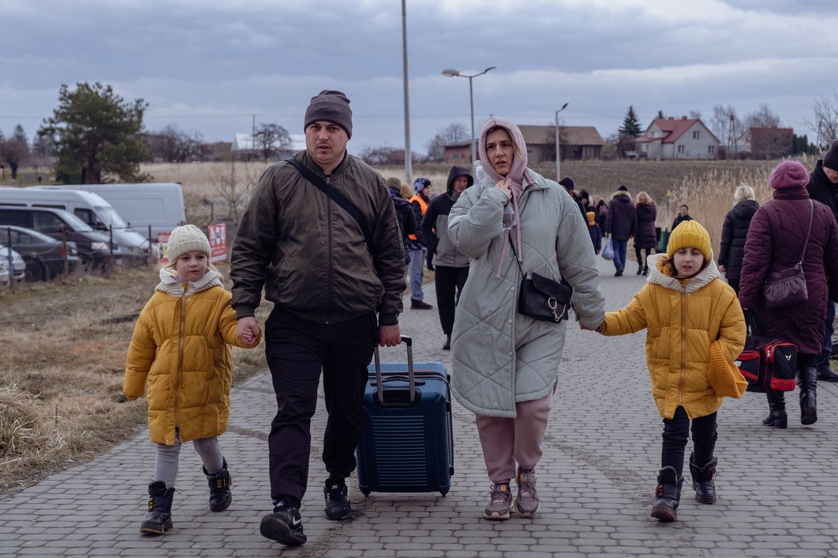 MEDYKA, POLAND - 2022/02/25: Ukrainian family seen after crossing polish border on the second day of Russian invasion of Ukraine. Ukraine - Polish border was crossed by millions of Ukrainian people. Polish people took many refugees into their homes. Russia invaded Ukraine on 24 February 2022, triggering the largest military attack in Europe since World War II. (Photo by Amadeusz Swierk/SOPA Images/LightRocket via Getty Images)