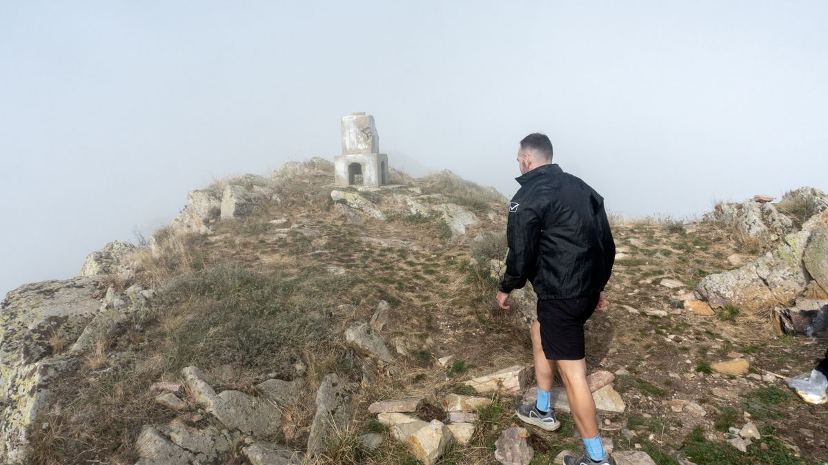 RHODOPE, GREECE - NOVEMBER 4: A man hikes on a rocky trail at Karlik Mountain, one of the favorite destination for nature lovers, during a foggy weather in Rhodope, Greece on November 4, 2024. The mountain, which is also known for being an important monastery centre during the Byzantine Period, offers an ideal environment for trekking with its weather and pine forests. (Photo by Ayhan Mehmet/Anadolu via Getty Images)