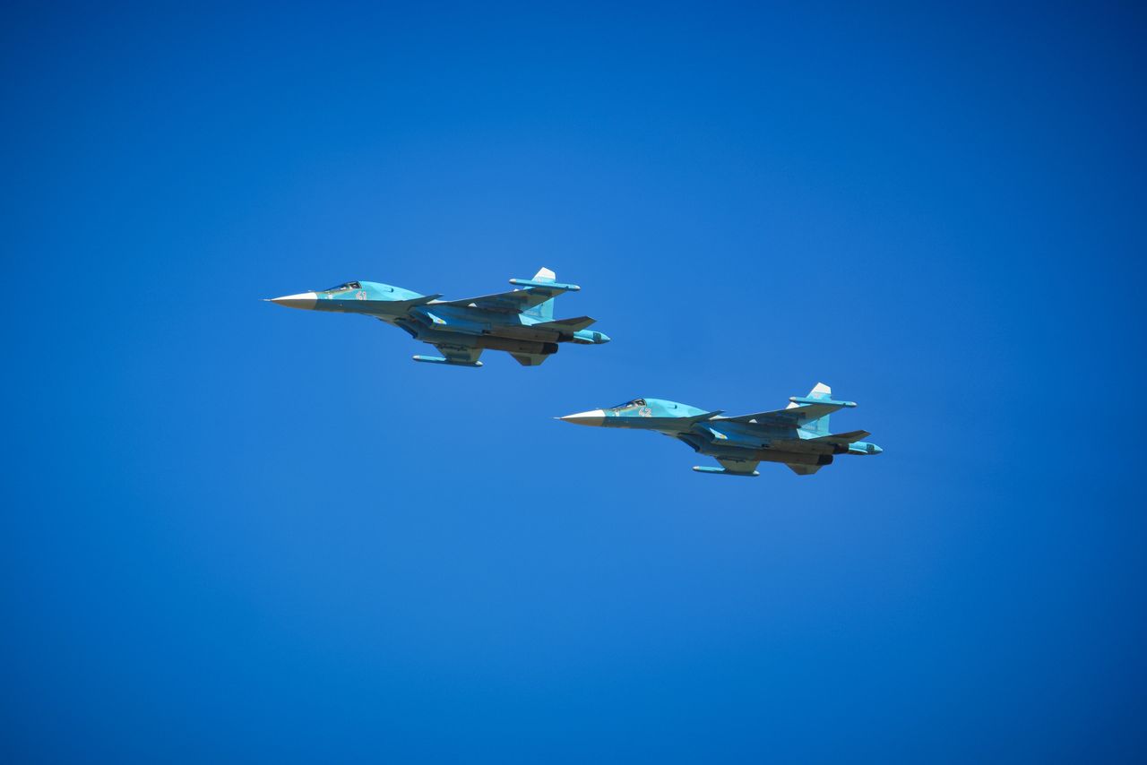 Two Russian Su-34 fighter-bombers flying on the clean sky.