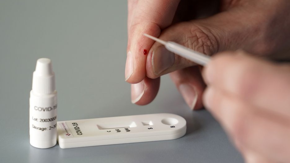 DERBY, ENGLAND - MARCH 16: In this photo illustration, a worker demonstrates the use of a Coronavirus, Covid-19, 10 minute blood test on March 16, 2020 in Derby, England. Surescreen Diagnostics based in Derby claim the new blood test can give a result for Covid-19 within 10 minutes. The test can be self administered with capillary blood taken from a fingertip. The result in the test cassette is viewed in a similar way to a pregnancy test. The Derbyshire company is increasing production and says the ten minute test 'costs a few pounds' GBP. (Photo illustration, by Christopher Furlong/Getty Images)