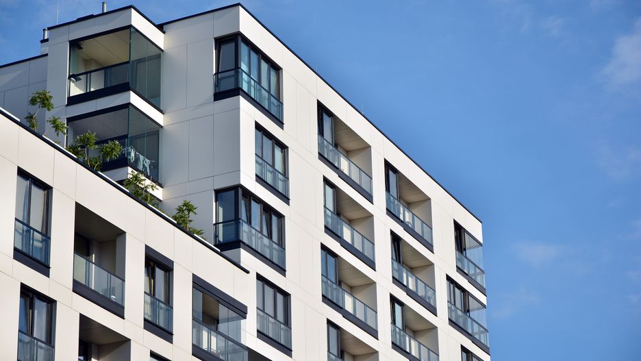 Modern apartment buildings on a sunny day with a blue sky.
Facade of a modern apartment building
Grand Warszawski