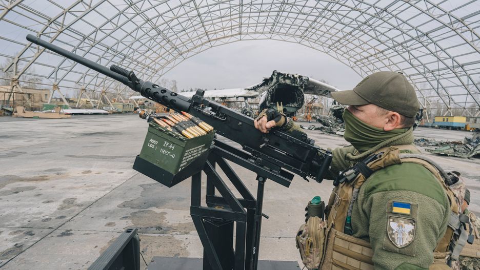 A Ukrainian soldier displays an M2 Browning machine gun during a handover of mobile anti-aircraft pick-up trucks by Herocar, as part of the Guardians of the Sky project, at Gostomel airfield, outside Kyiv, Ukraine, on Saturday, April 1, 2023. The International Monetary Funds board signed off on a $15.6 billion aid package for Ukraine, the final approval for the institutions first-ever loan to a nation at war. Photographer: Andrew Kravchenko/Bloomberg via Getty Images