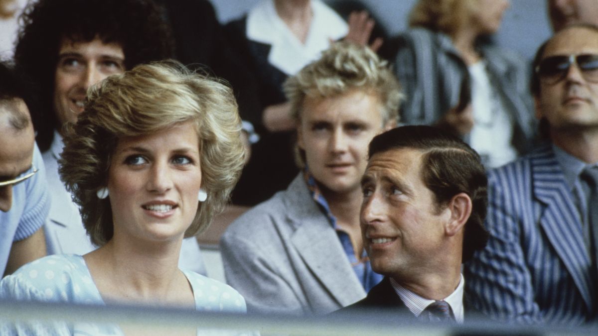 British Royals Diana, Princess of Wales, wearing a dress designed by Dale 'Kanga' Tryon, with her husband Charles, Prince of Wales, during the Live Aid concert at Wembley Stadium in London, England, 13th July 1985. Behind the Royal couple are Queen musicians, guitarist Brian May and drummer Roger Taylor. (Photo by Fox/Keystone/Hulton Archive/Getty Images)