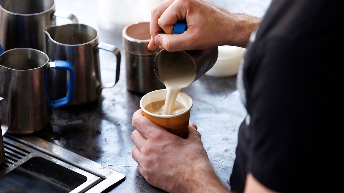 A barista pours milk into a takeaway coffee cup at Carriageworks Farmers Market in Sydney, Australia, on Saturday, April 26, 2025. Australia is scheduled to release consumer price index (CPI) figures on April 30. Photographer: Brendon Thorne/Bloomberg via Getty Images