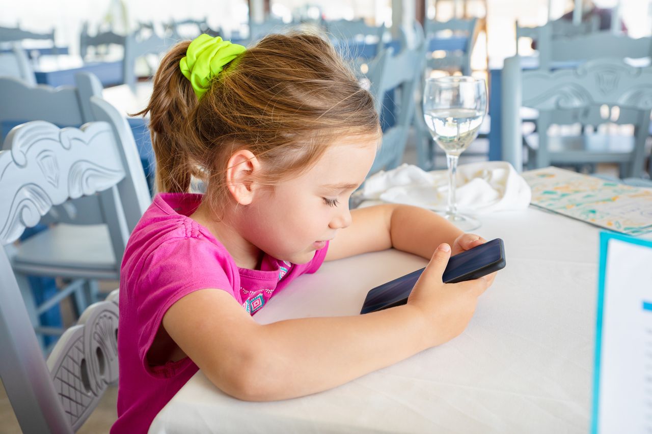 Dziecko z telefonem w restauracji