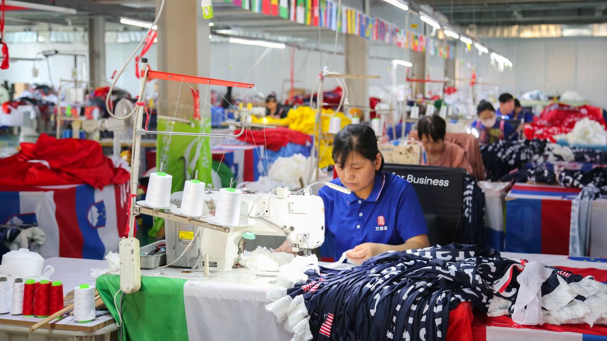 QINGDAO, CHINA - MAY 28: Workers are busy in front of an assembly line of flags for the FIFA World Cup at Qingdao Wonderful Flag Industry Co on May 28, 2026 in Qingdao, Shandong Province of China. As the 2026 FIFA World Cup is around the corner, production lines at a flag manufacturer in Qingdao, Shandong province, are running at full speed to produce various types of flags, many of which will soon appear in stadiums across North America. (Photo by Zhang Guangming/VCG via Getty Images)