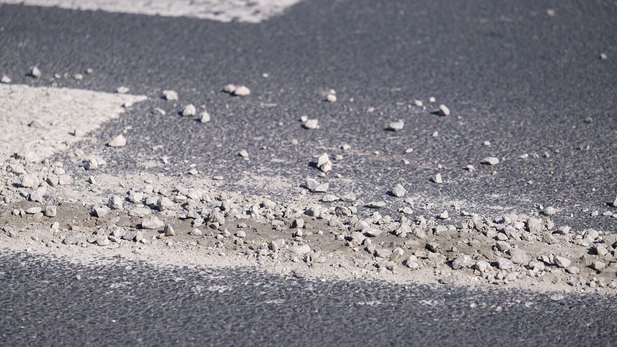 Rozlany beton z kamieniami na jezdni