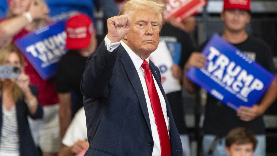 ATLANTA, GA - AUGUST 3- Former President and current Republican presidential nominee Donald Trump raises his fist as he leaves the stage during a campaign event on Saturday, August 3, 2024 in Atlanta, GA. (Photo by Elijah Nouvelage for The Washington Post via Getty Images)