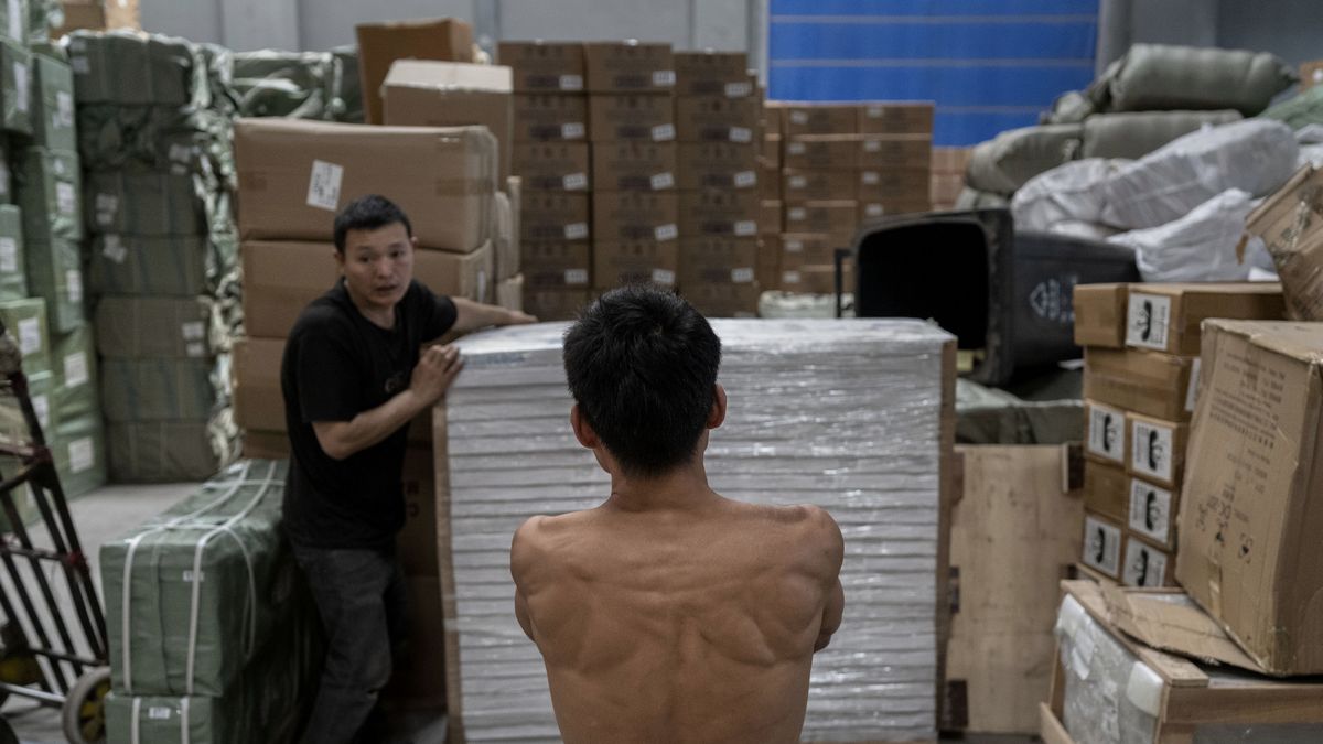 YIWU, CHINA - APRIL 29: Workers move goods for export before loading them on a container at a logistics hub on April 29, 2025 in Yiwu, Zhejiang Province, China. The Yiwu area is home to thousands of China's small commodities companies, many of which in recent years due to trade tensions with the United States have looked to the Middle East, Africa, Europe and South America for new business. After President Trump put tariffs as high as 145 percent on Chinese goods, many producers saw orders from American clients cancelled or at least temporarily put on hold. (Photo by Kevin Frayer/Getty Images)