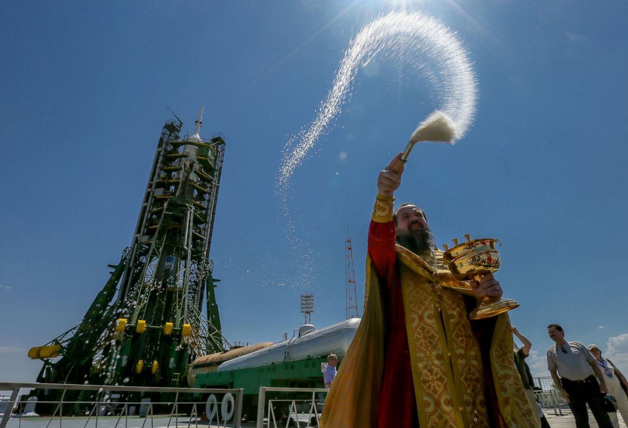 Prawosławny kapłan przed startem święci rakietę i statek Sojuz