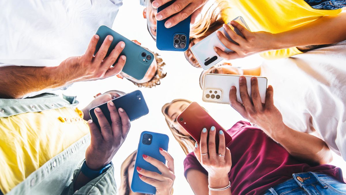 Teens in circle holding smart mobile phones - Multicultural young people using cellphones outside - Teenagers addicted to new technology conceptaddicted, app, business, cell, cellphone, cellular, communication, connection, device, digital, friends, friendship, game, gen z, generation, group, hands, holding, internet, lifestyle, media, meeting, message, millenial, millennials, mobile, modern, network, online, outdoors, people, phone, smart, smartphone, sms, social, students, tablet, team, tech, technology, teenage, teenagers, text, together, trendy, using, watching, young, youth