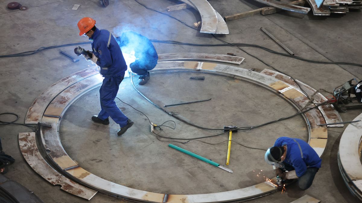 HUZHOU, CHINA - DECEMBER 16: Workers manufacture core equipment for photovoltaic projects at Zhejiang Dachuan Air Separation Plant Co., Ltd. on December 16, 2025 in Huzhou, Zhejiang Province of China. The core equipment for photovoltaic projects will be exported to Southeast Asian countries. (Photo by Ni Lifang/VCG via Getty Images)