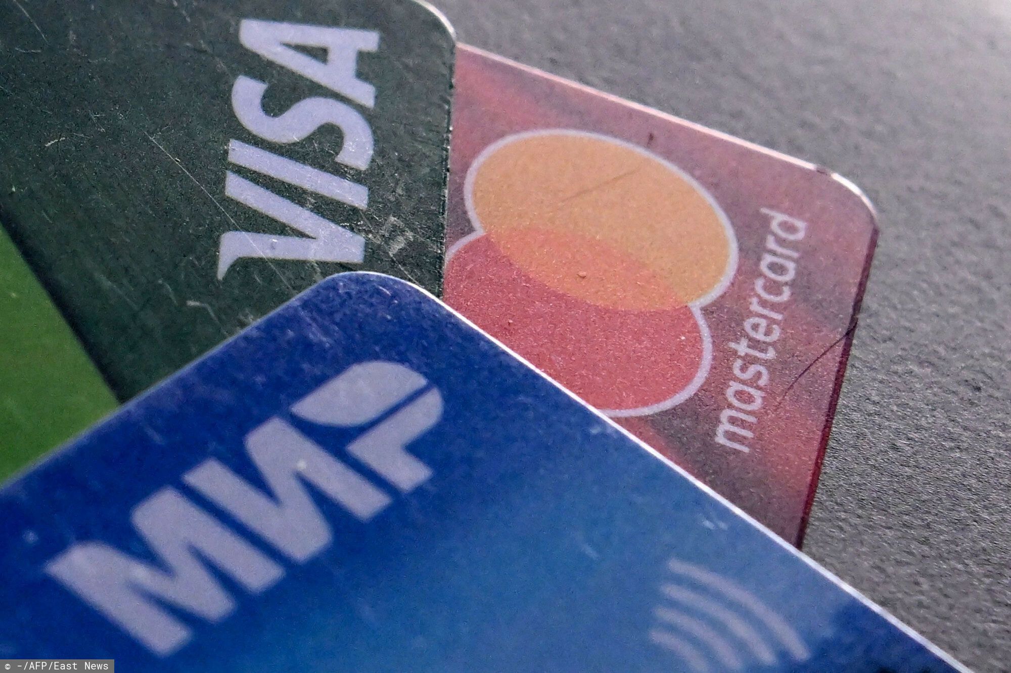 Temporary
A photo taken on March 14, 2022, shows the logos of Visa, Mastercard and Russian Mir payment systems on bank cards in Moscow. (Photo by AFP)
-