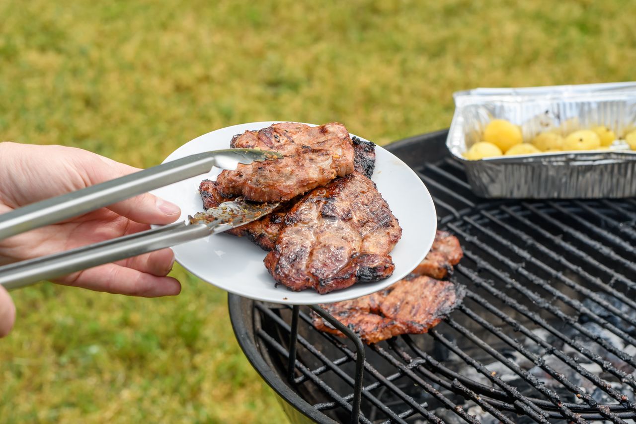 Grilled pork neck served on a plate in the garden