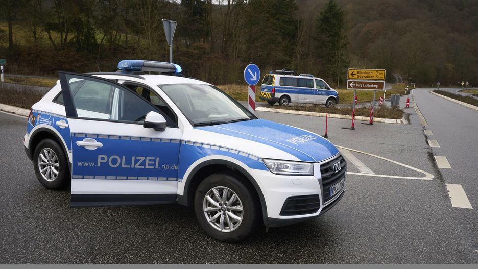 TemporaryPolice officers block the access road to the scene where two police officers were shot during a traffic stop near Kusel, Germany, Monday, Jan. 31, 2022. Police say two officers have been shot dead while on a routine patrol in western Germany. Police in Kaiserslautern said the shooting happened during a traffic check near Kusel at about 4:20 a.m. on Monday. They said that the perpetrators fled but police had no description of them, the car they used or what direction they fled in. Police called on drivers in the Kusel area not to pick up hitchhikers and warned that at least one suspect is armed. (Thomas Frey/dpa via AP)DPA