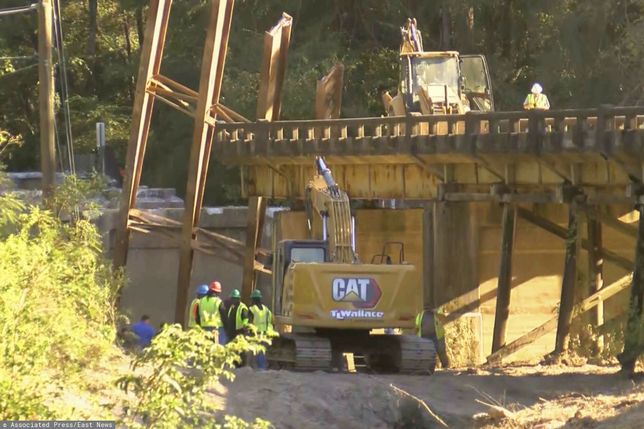 TemporaryThis image taken from video from WLBT shows construction workers at the scene after a bridge over the Strong River on State Route 149 in Simpson County, Miss., collapsed on Wednesday, Oct. 16, 2024. (WLBT via AP)