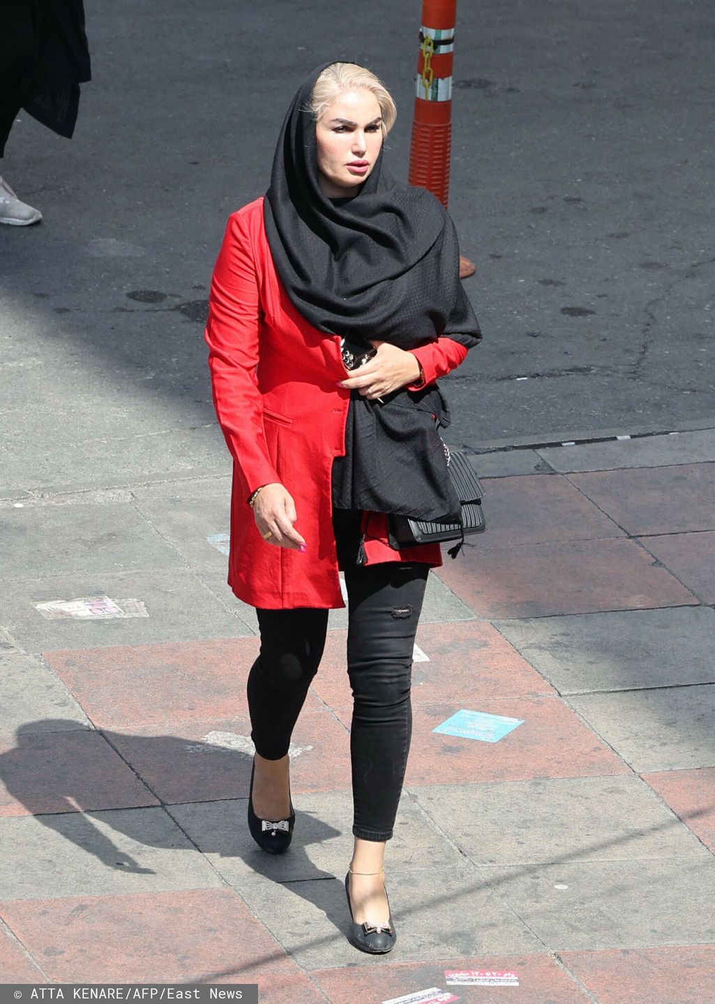 TemporaryAn Iranian woman walks in a street in the capital Tehran on September 21, 2022. - Protests spread to 15 cities across Iran overnight over the death of the young woman Mahsa Amini after her arrest by the country's morality police, state media reported on today. In the fifth night of street rallies, police used tear gas and made arrests to disperse crowds of up to 1,000 people, the official IRNA news agency said. (Photo by ATTA KENARE / AFP)ATTA KENARE