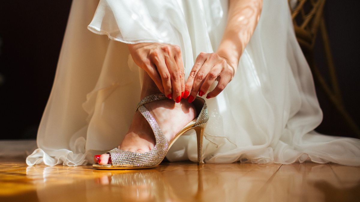 Bride putting on her shiny wedding high heels
Bride putting on her shiny wedding high heels
JovanaT