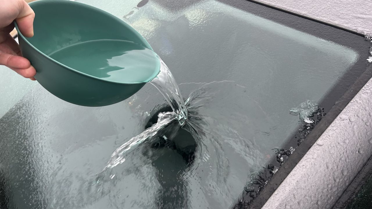 Pouring warm water on the window