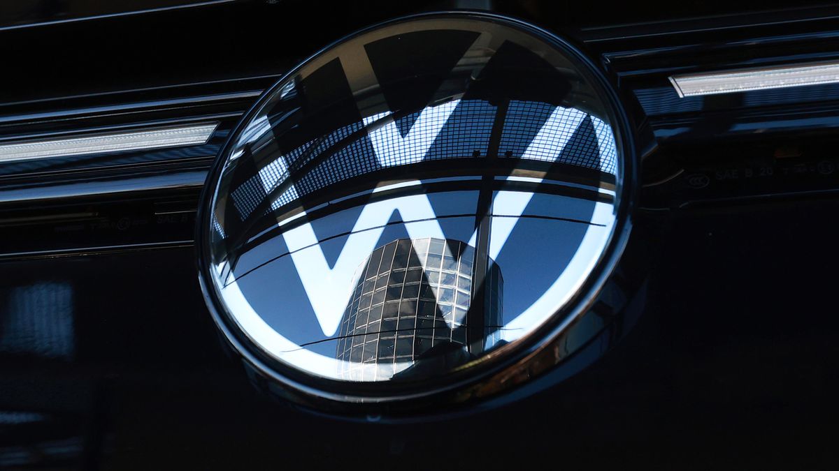 An Autostadt delivery tower reflected in the badge of a Volkswagen AG (VW) Golf automobile at the automaker's headquarters and auto plant in Wolfsburg, Germany, on Tuesday, Feb. 28, 2023. Volkswagen wants to remain a strong player in Europe and China, but in the face of growing geopolitical tensions and an increasingly complex regulatory environment, the German carmaker is looking beyond the US for markets with growth potential. Photographer: Krisztian Bocsi/Bloomberg via Getty Images