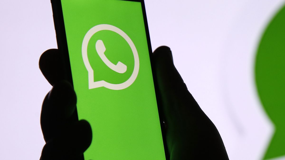 PARIS, FRANCE - DECEMBER 10: In this photo illustration, the WhatsApp logo is displayed on the screen of an iPhone in front of a TV screen displaying the WhatsApp logo on December 10, 2019 in Paris, France. The WhatsApp instant messenger service will stop working on millions of phones in the next couple of months as the company withdraws support for some older mobile platforms. From February 1, 2020, any iPhone running iOS 8 or older will no longer be supported, along with any Android device running version 2.3.7 or older. (Photo by Chesnot/Getty Images)