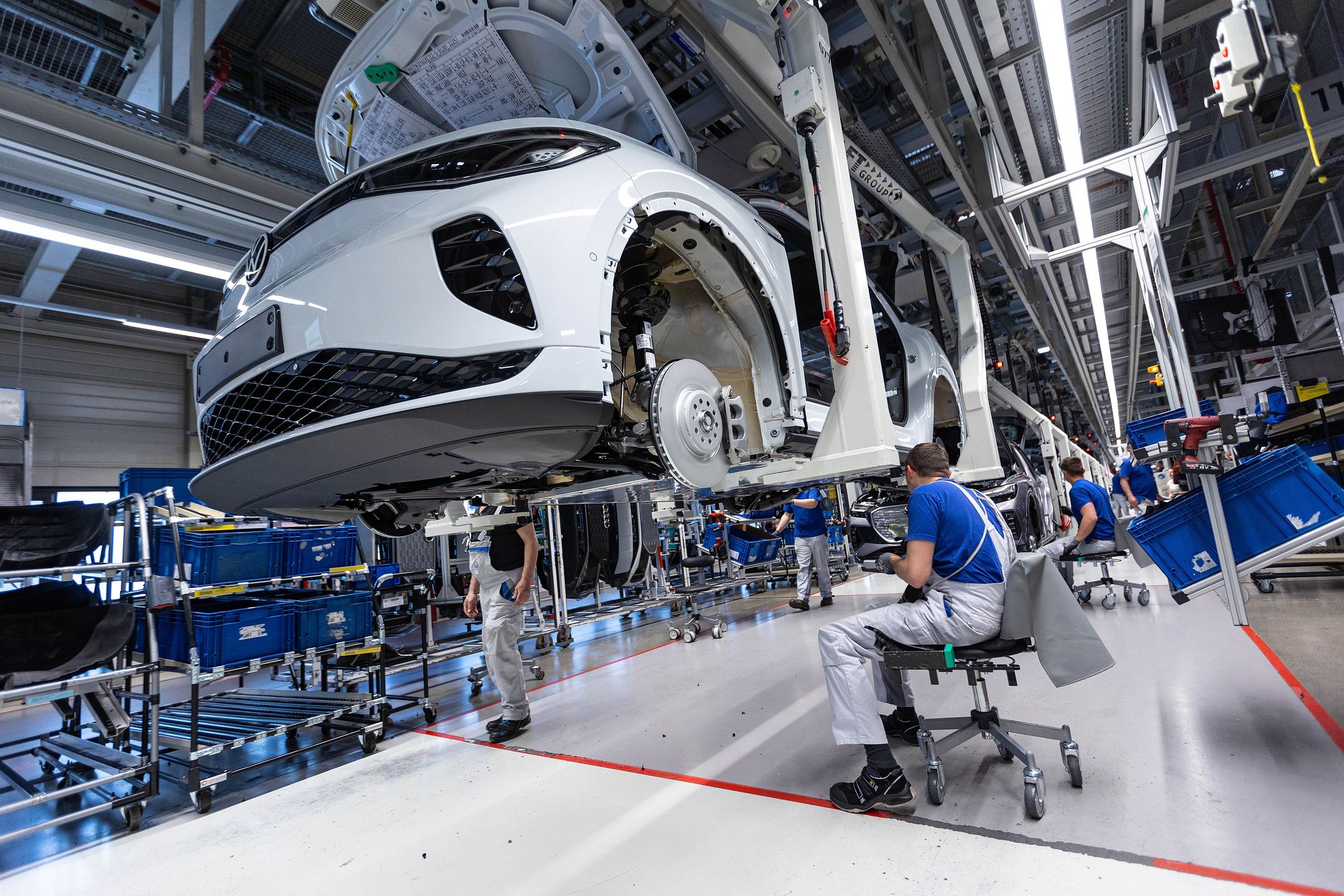 Employees work on the bodies of Volkswagen AG (VW) ID.5 electric sports utility vehicles (eSUV) on the assembly line at the automaker's electric automobile plant in Zwickau, Germany, on Tuesday, April 26, 2022. The Zwickau assembly lines are the centerpiece of a plan by VW, the world's biggest automaker, to manufacture as many as 330,000 cars annually. Photographer: Krisztian Bocsi/Bloomberg via Getty Images