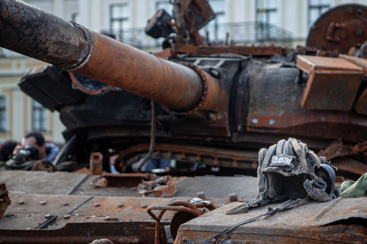 KYIV, UKRAINE - 2022/05/23: A view of a damaged headwear of a Russian serviceman placed on top of a destroyed Russian tank in central Kyiv. The Ministry of Internal Affairs and the National Museum of the History of Ukraine have put on display outside St. Michael's Golden-Domed Monastery several pieces of destroyed Russian equipment as part of an exhibition titled "Ukrainian War of Independence 2022". (Photo by Richard Wright/SOPA Images/LightRocket via Getty Images)